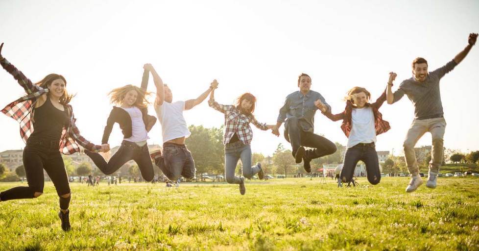 Group-of-people-jumping-on-the-park-at-dusk