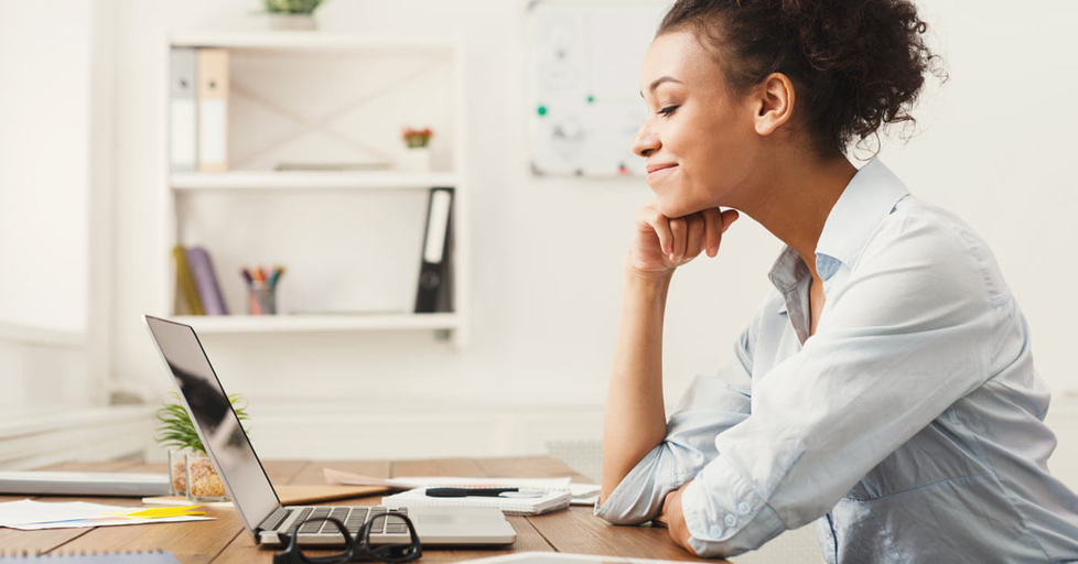 Happy-business-woman-working-laptop-office