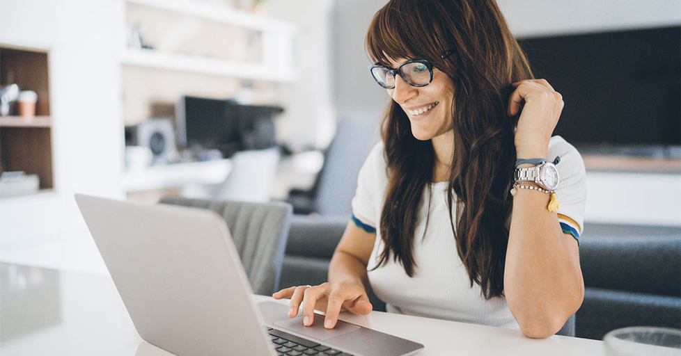 Happy-woman-looking-at-computer