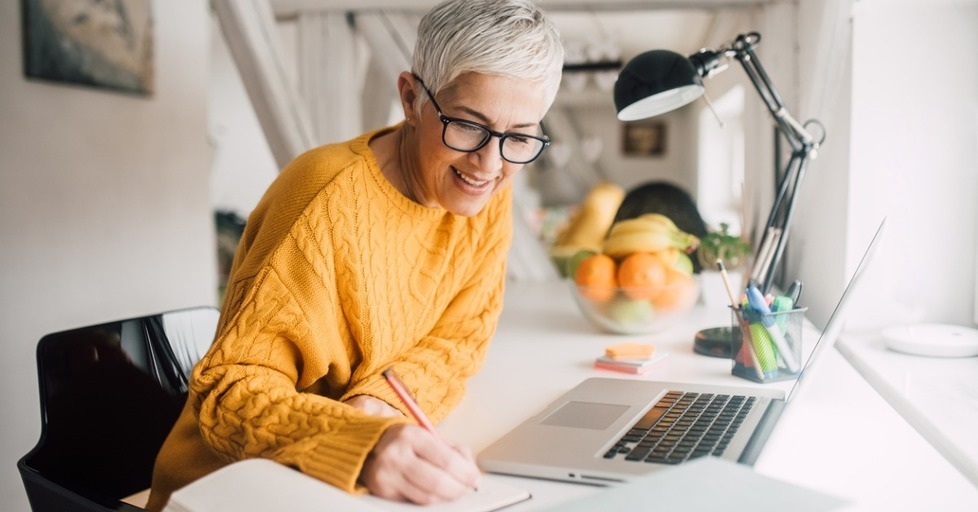 Older_woman_writing_at_desk